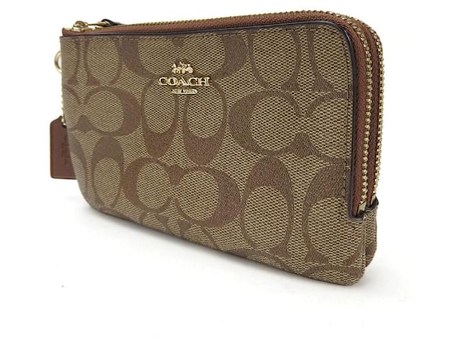 Pochette in PVC con firma Coach Marrone